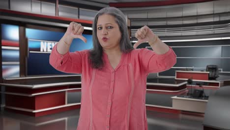 Disappointed-Indian-senior-female-journalist-showing-thumbs-down