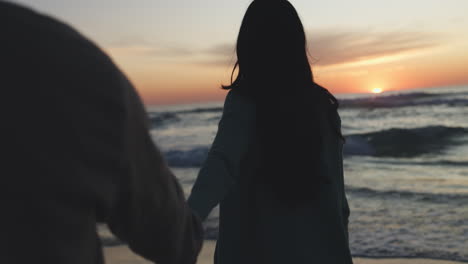 love, sunset and couple walking on a beach