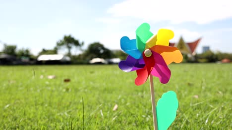 a vibrant pinwheel rotates outdoors on a sunny day.