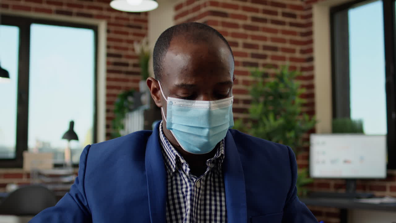 Businessman taking notes on statistics documents with web report