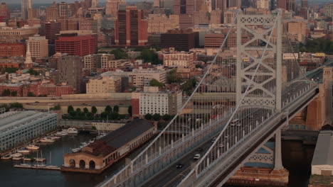 aerial view of philadelphia's ben franklin bridge. shot along the delaware river at sunrise on a summer morning