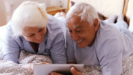 senior couple using digital tablet