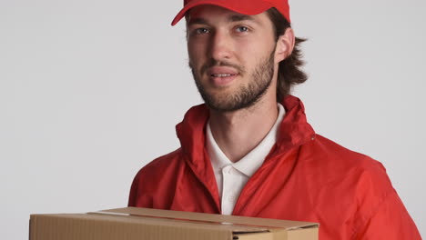 Caucasian-delivery-man-in-front-of-camera-on-white-background.