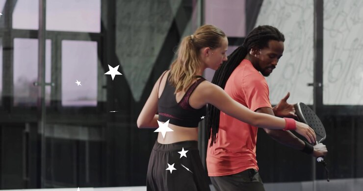Coach swinging padel racket in sports training and guiding trainee as animated white stars swirling