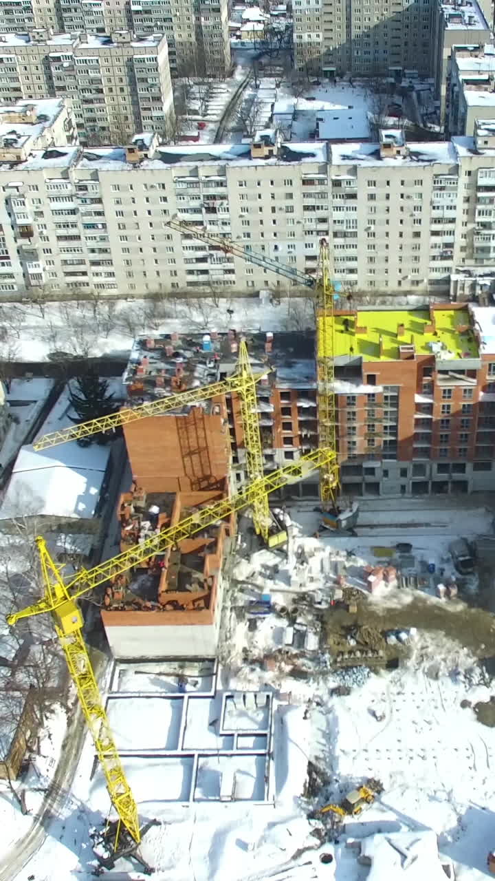 Construction site with cranes. Under construction high-rise building with construction cranes