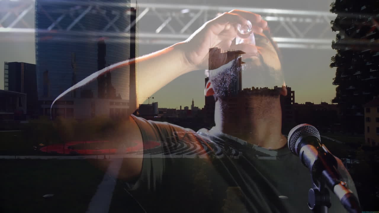 Male presenter adjusting in-ear monitor on stage while technology overlaying urban skyline visuals