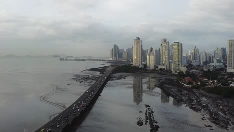 heavy overcast aerial of panama city waterfront with highway bridge