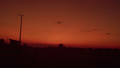 Vibrant-sunset-hues-painting-the-sky-over-Arauca,-Colombia,-silhouette-of-landscape