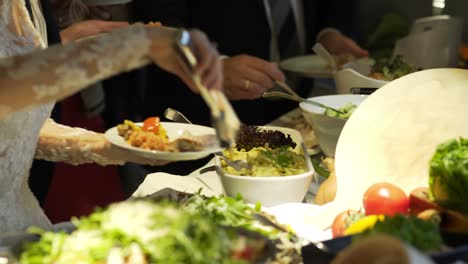 restaurant guests select food from a buffet