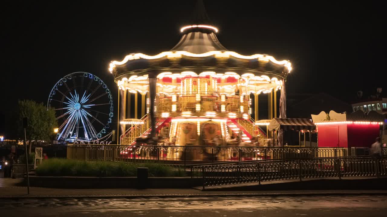 Time lapse of the vintage children's carousel illuminated at night