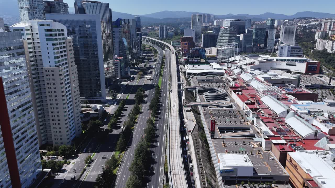 Drone footage capturing intercity train as it arrives in bustling Santa Fe, Mexico City