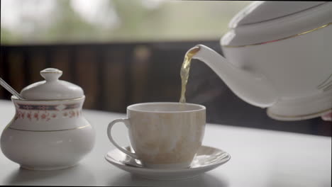 slow motion pouring tea with soft blurred background