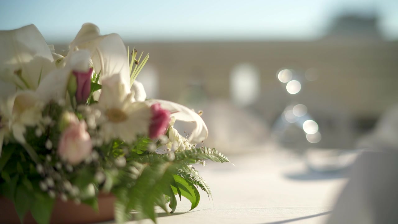 Elegant Table Setting with Floral Centerpiece at Outdoor Event
