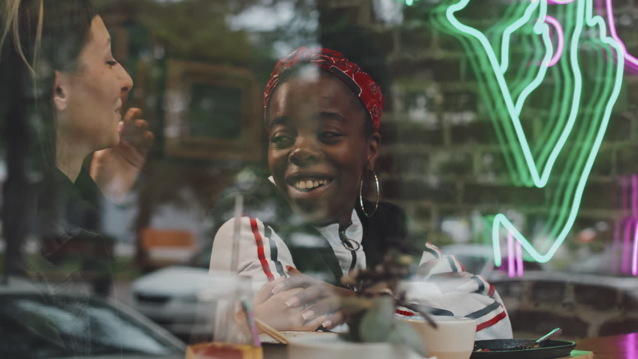 Happy Lesbian Couple Chatting on Date in Cafe