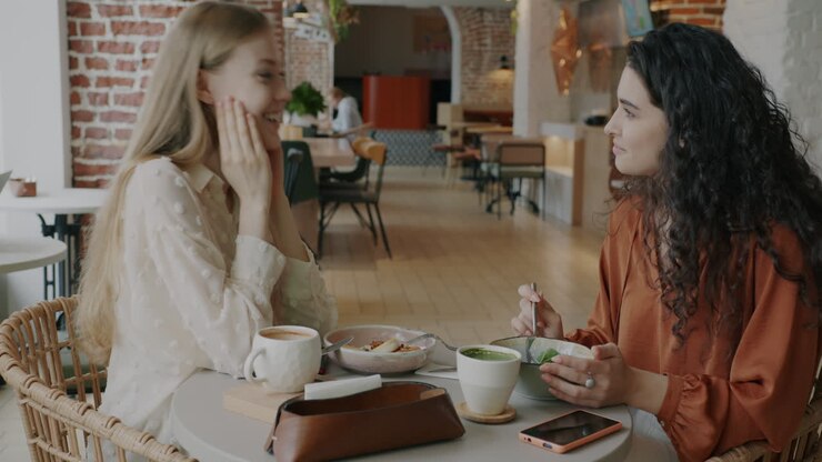 Two Women Enjoying a Casual Lunch at a Cafe