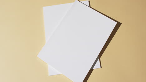 video of books with blank white pages and copy space on yellow background