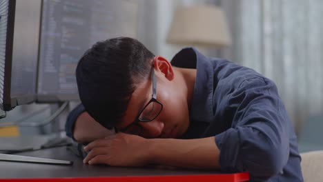 tired programmer taking a nap at desk