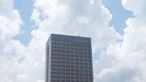 tall gray building against cloudy sky