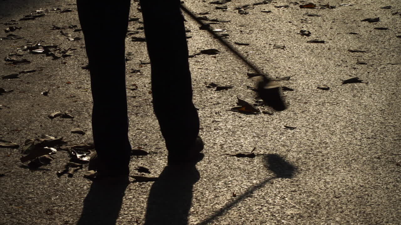 Man sweeping street in the late evening in Havana, Cuba