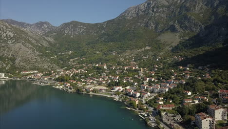 risan in montenegro, filmed from the air with mountains behind and the bay of kotor in front