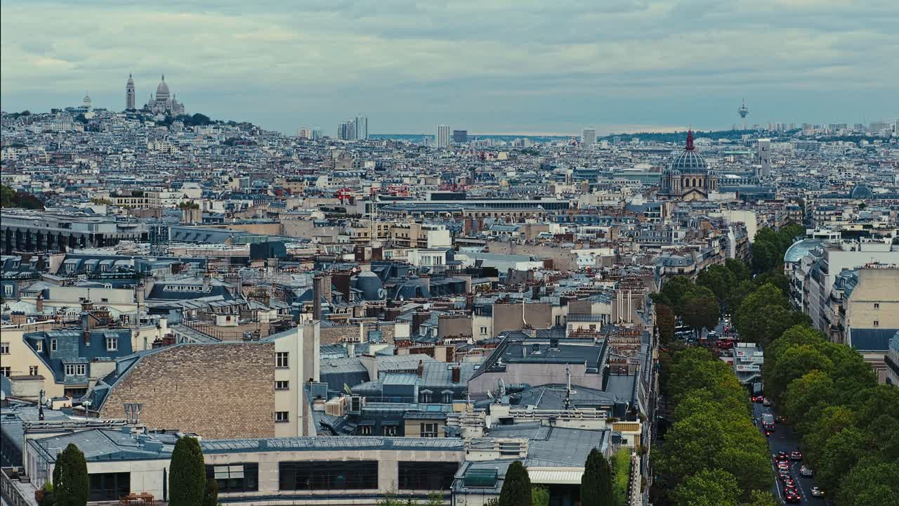 Aerial view of Sacre Couer Cathedral high above the rooftops of Paris, France. Static handheld wide shot