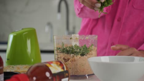 agregar ingredientes a un procesador de alimentos para hacer pasteles de cangrejo