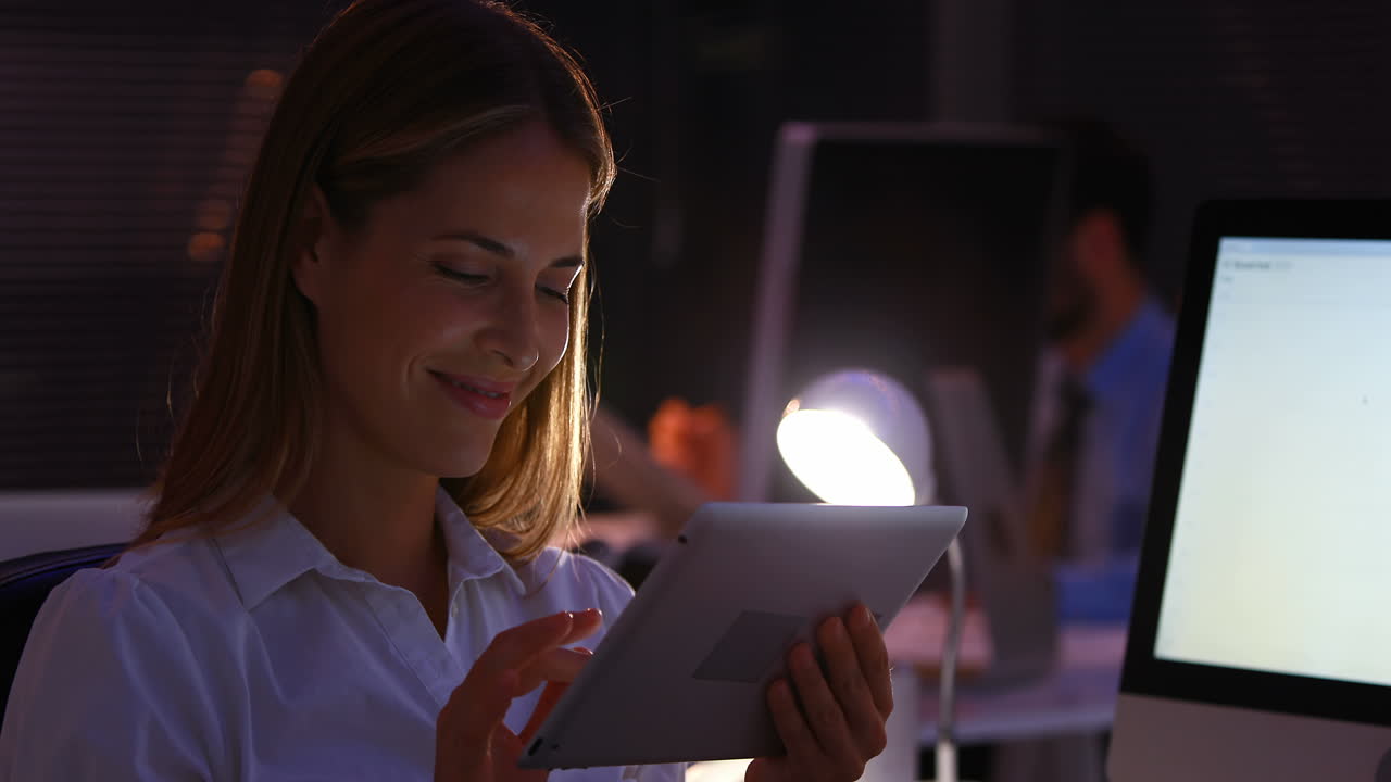 Businesswoman using a laptop at night