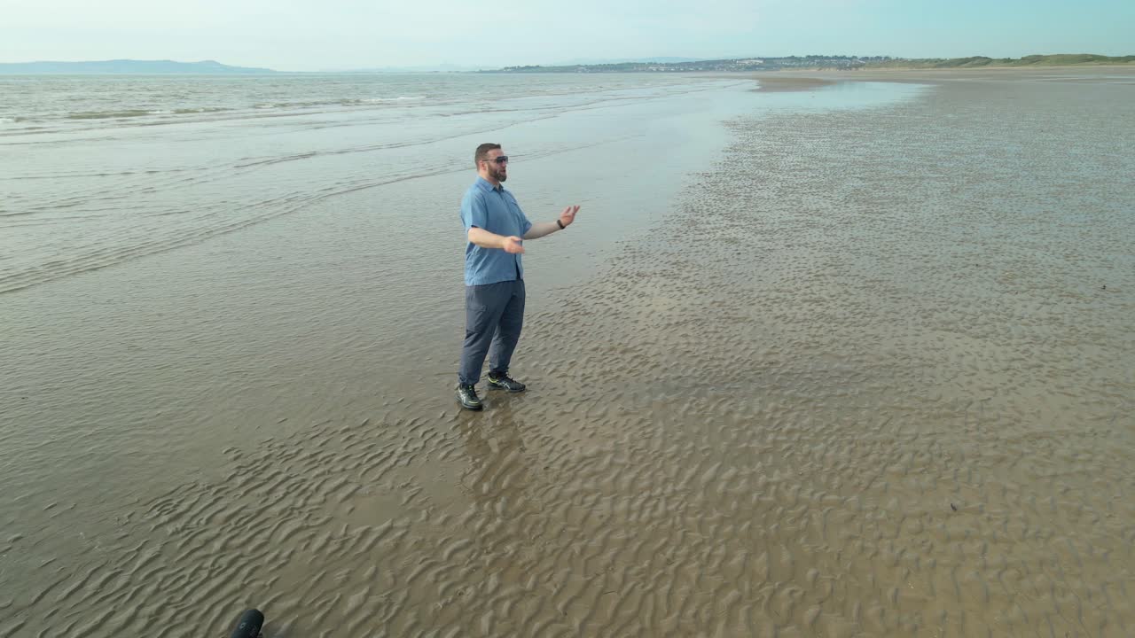 Male Rapper Showcasing Talent At Donabate Beach In Ireland. wide shot