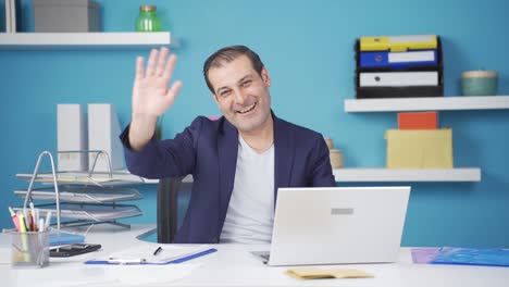 cheerful and happy happy businessman waving at camera.