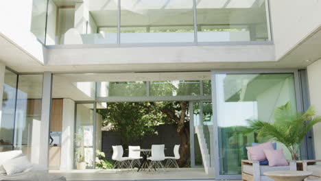 a modern home patio area bathed in sunlight with copy space