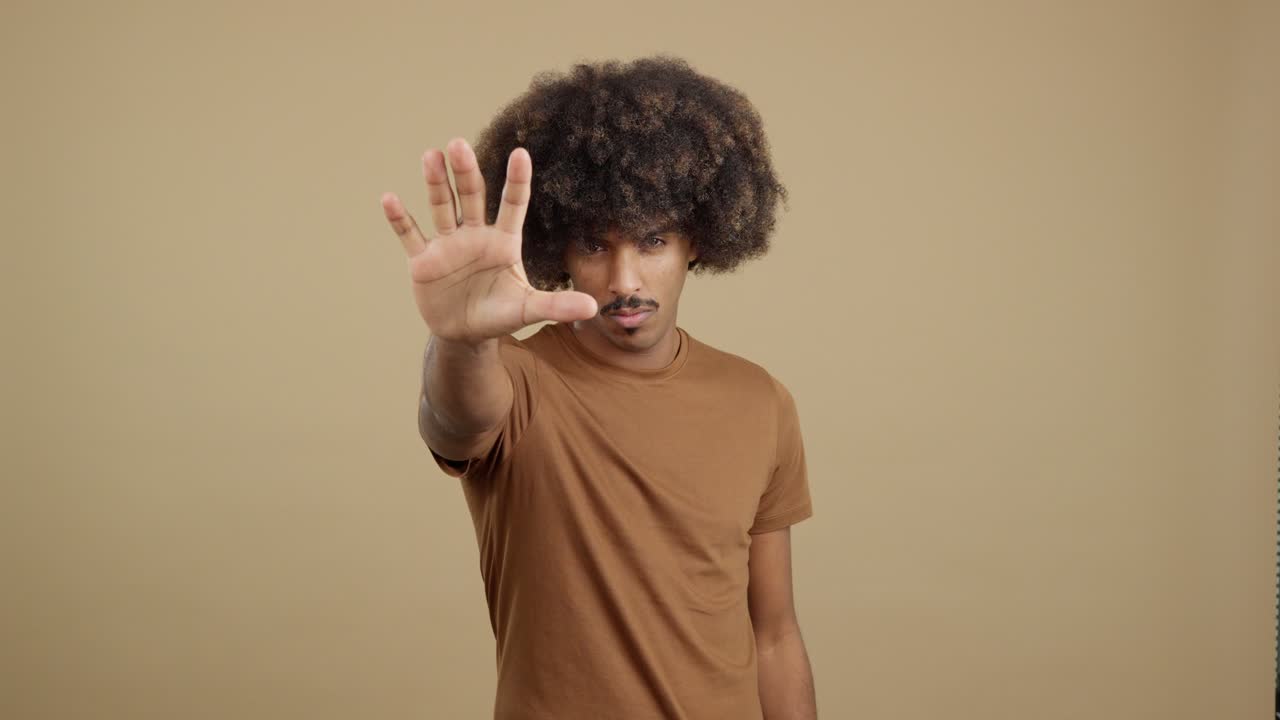 Man with Afro Hair Making Stop Gesture