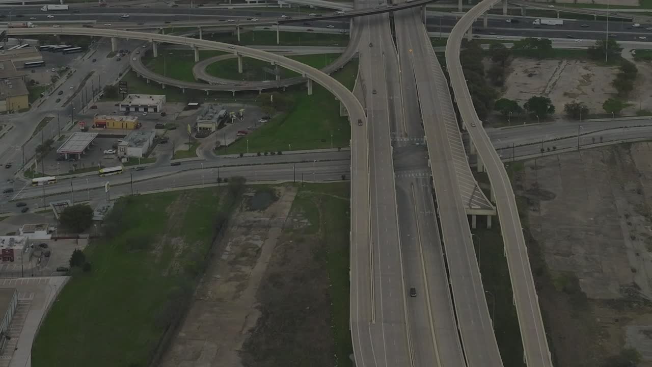 Dallas downtown aerial view shows highways and city activity at daytime