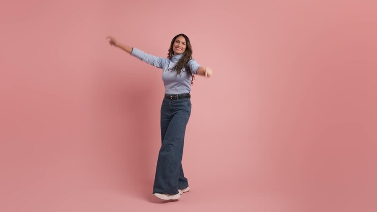 Adult colombian woman 30s wears casual clothes dancing on pink background