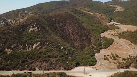 aerial view of winding road through mountainous landscape