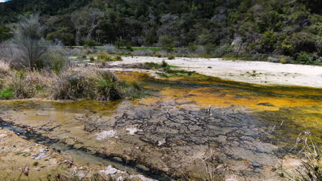 Panning-shot-of-volcanic-and-geothermal-scenery-during-sunny-day-in-Waimangu,New-Zealand