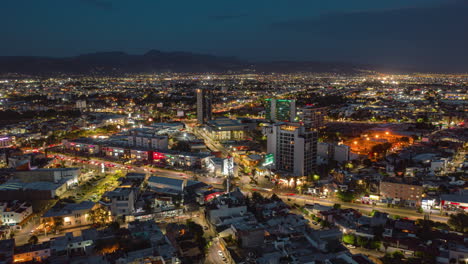 sunset-aerial-time-laps-on-the-city,-lights,-traffic-and-building