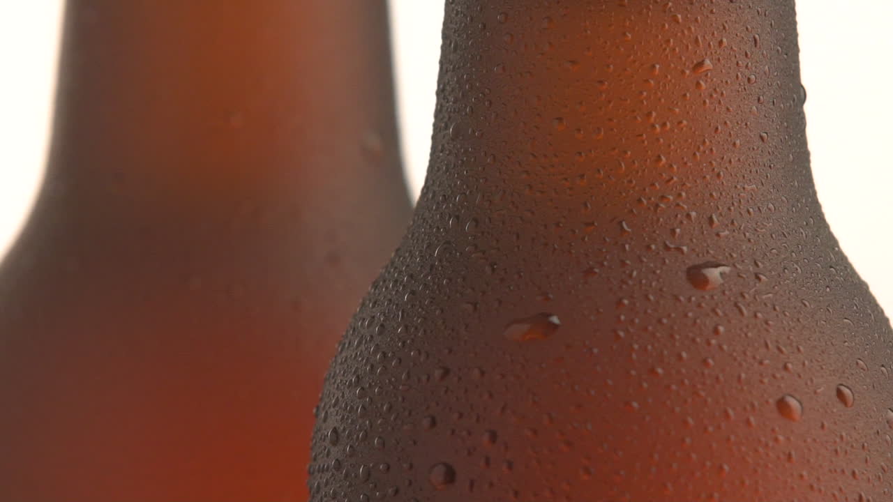Two beer bottle rotating on white background