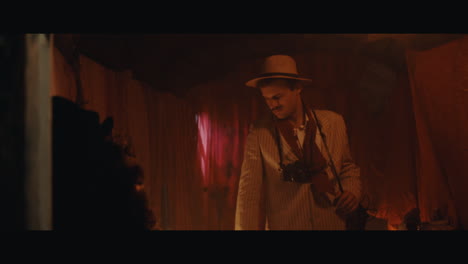 a man in hat checks the inside of the gypsy circus cart
