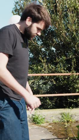 man washing hands at a fountain