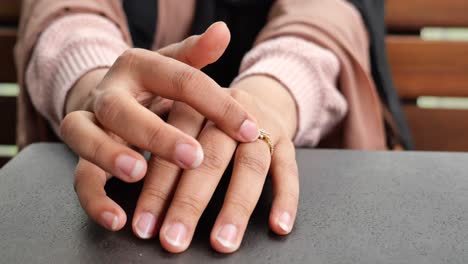 woman examining ring on finger