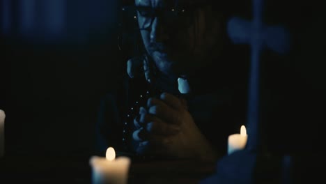 video capturing a table with magical tools on it a priest is sitting at the table with beads in his