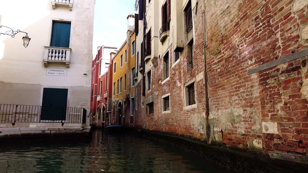 góndola de vela con vistas a edificios antiguos con paredes de ladrillo en venecia, italia