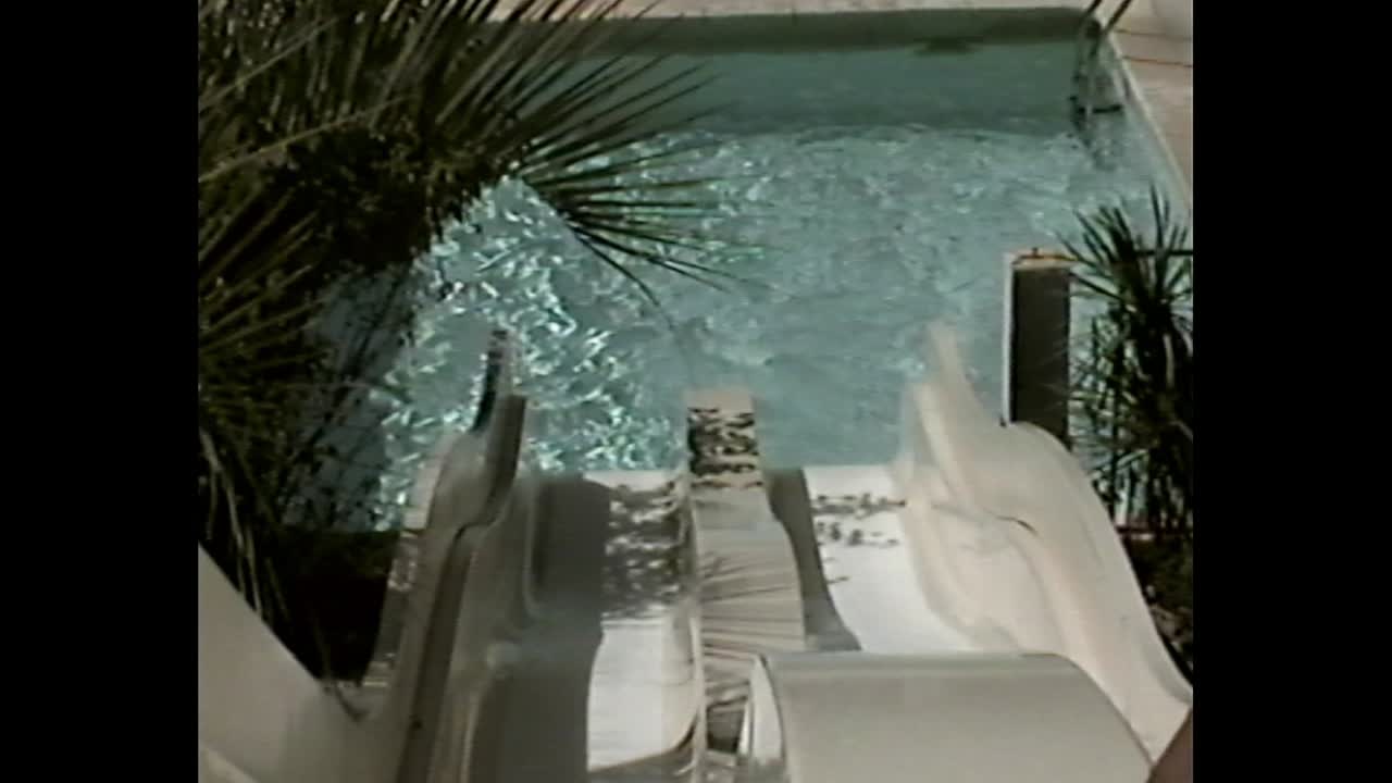 Person sliding down a waterslide into a pool