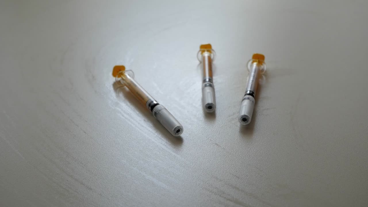 Three syringes on its containers