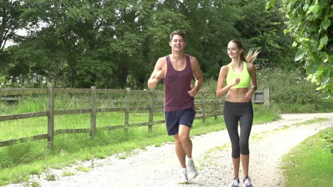 Slow-Motion-Shot-Of-Couple-On-Run-In-Countryside-Together