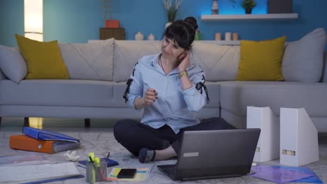 Home-office-worker-woman-scratches-her-ears-looking-at-camera.