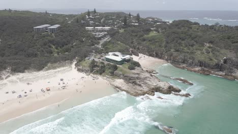 beach resorts near main beach headland reserve - tourists swim at south gorge and main beach in point lookout, qld, australia