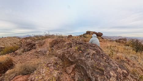 cloud time lapse of weaver needles and a hiker resting in the superstition mountains