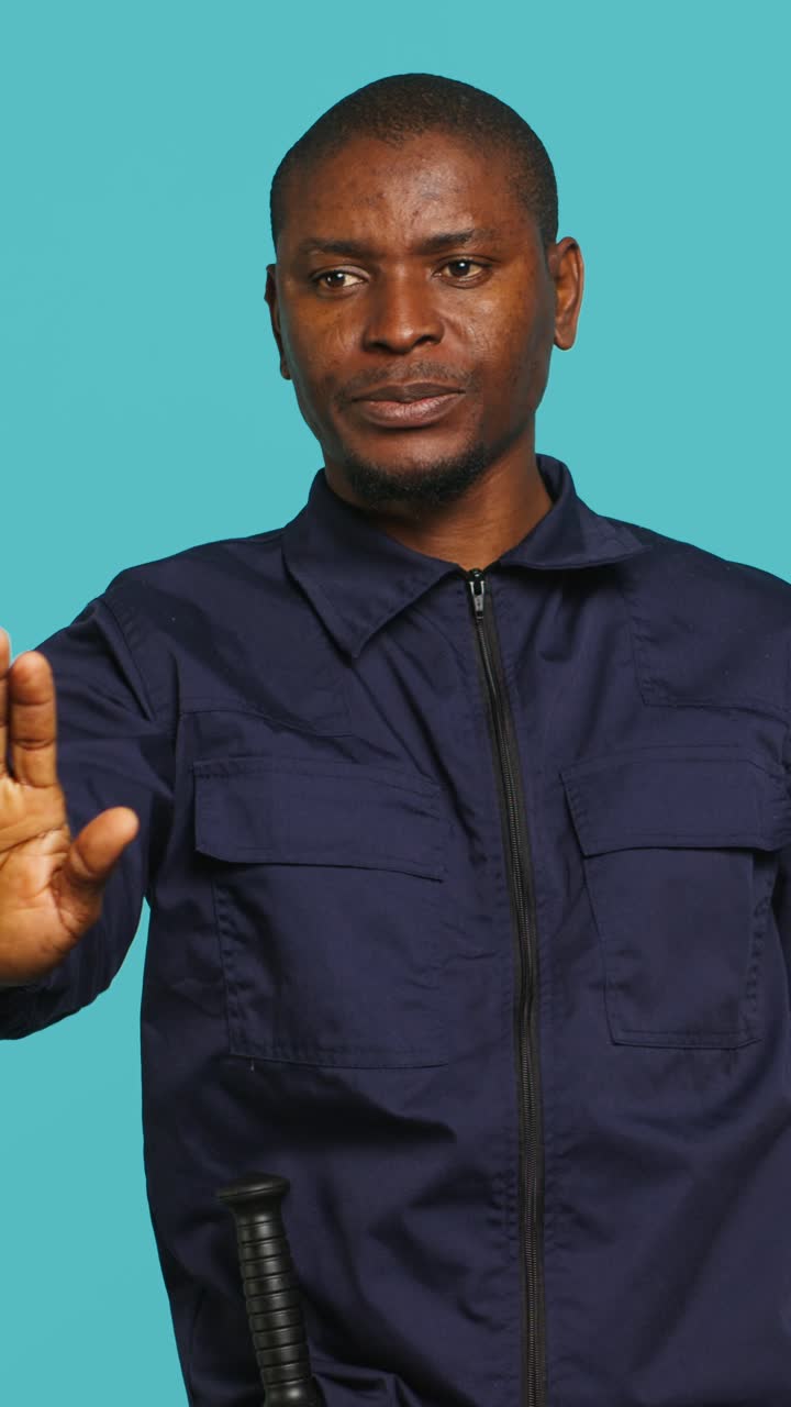 African Man in Uniform Making Stop Gesture