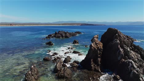 aerial view of rocky ocean barrier and coral reefs at low tide near tenacatita beach, la morita beach peninsula, jalisco costa alegre, mexico